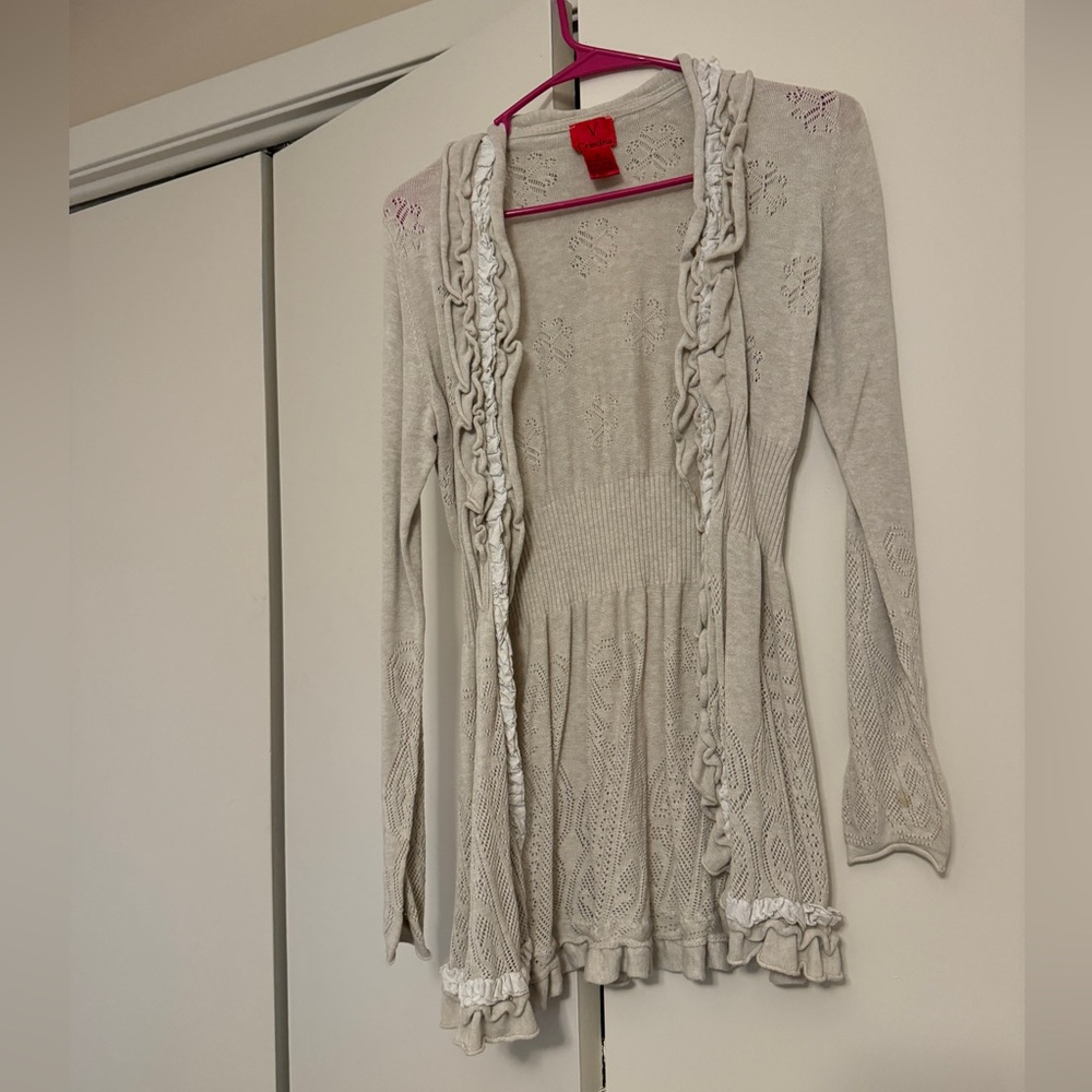 Light sweater with front hook closure. Pretty ruffle details, tunic length